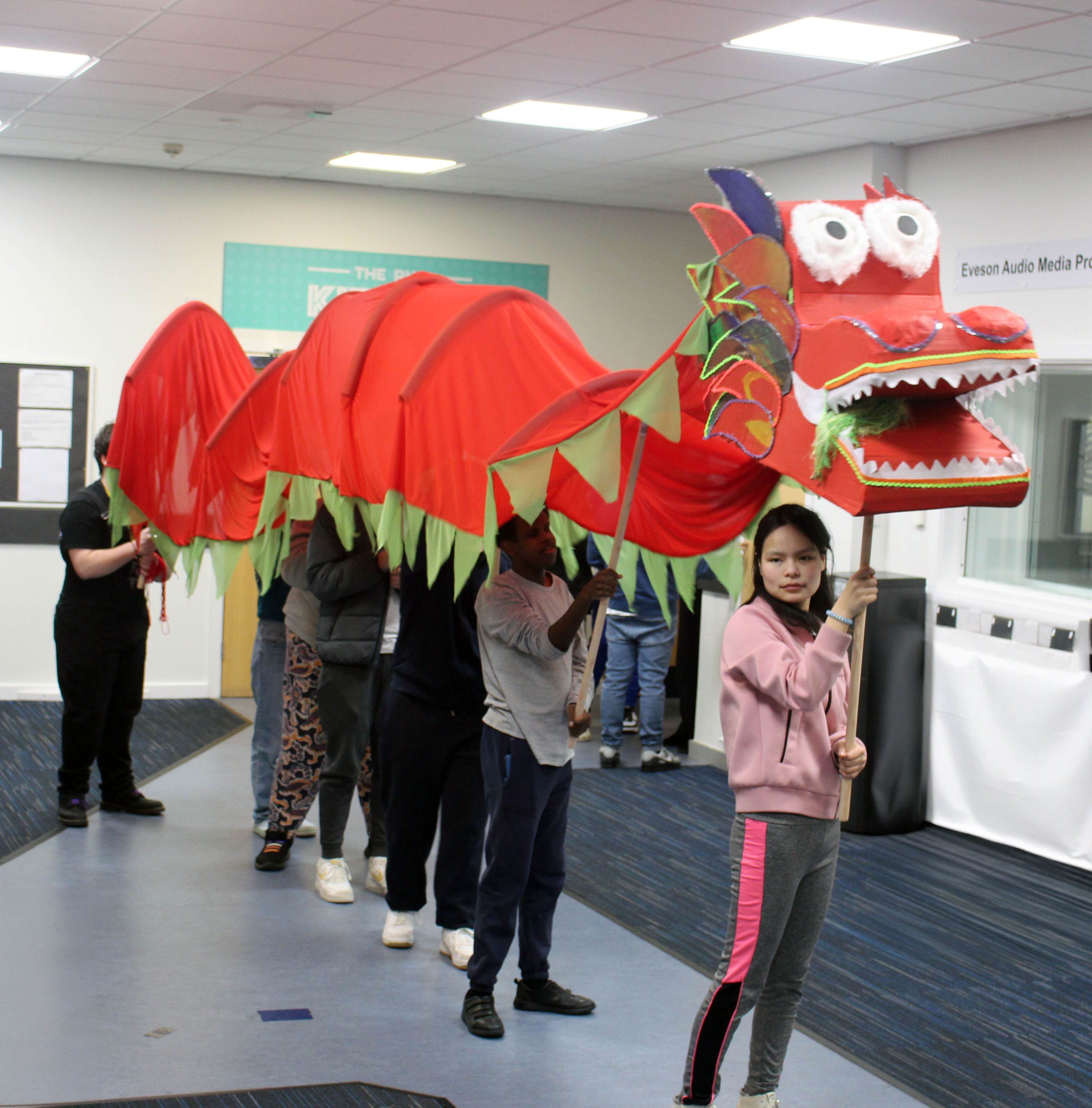 Guoguo at the head of the dragon with it's bright red body trailing behind