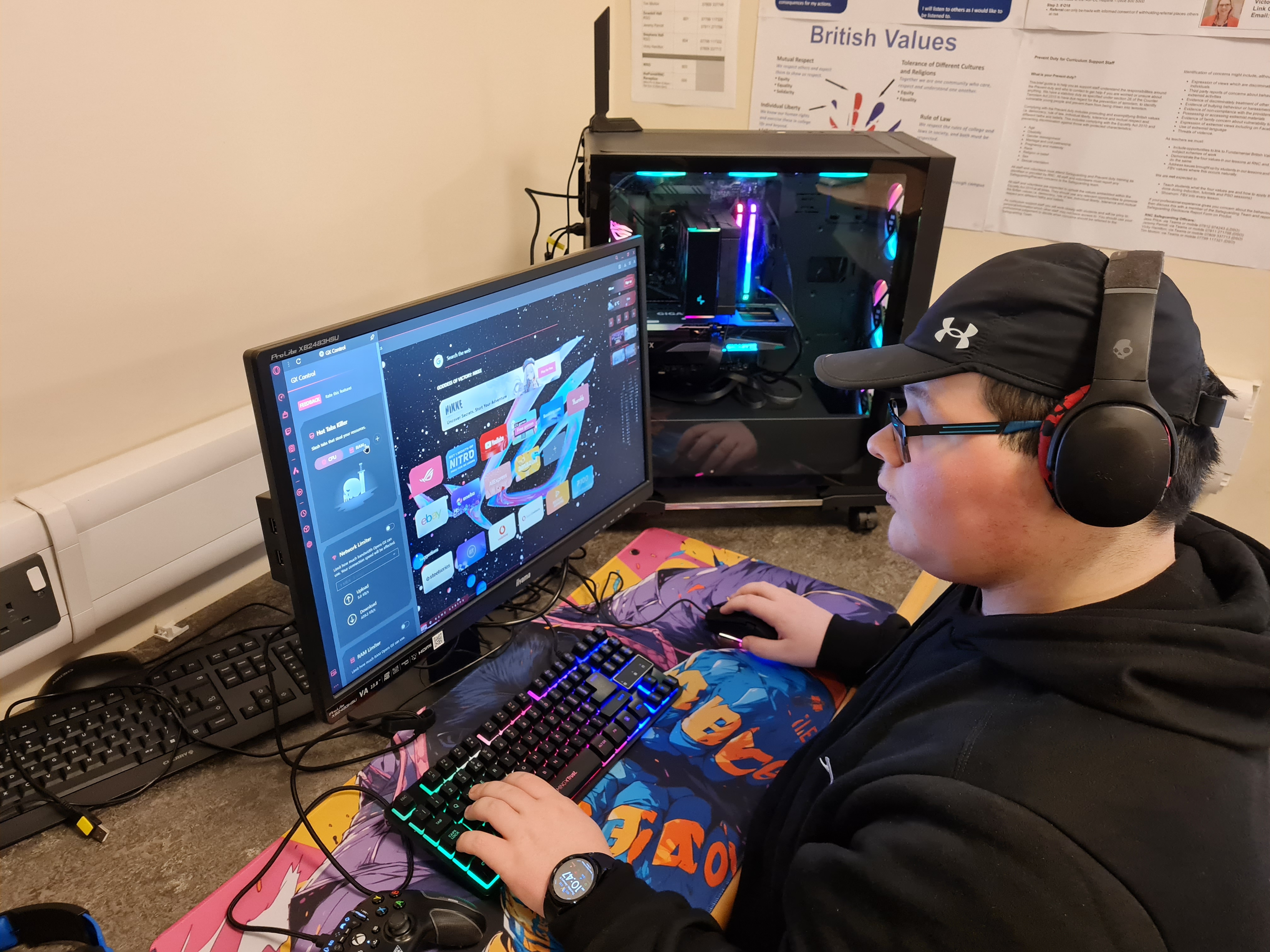 a student wearing headphones tests the newly built PC