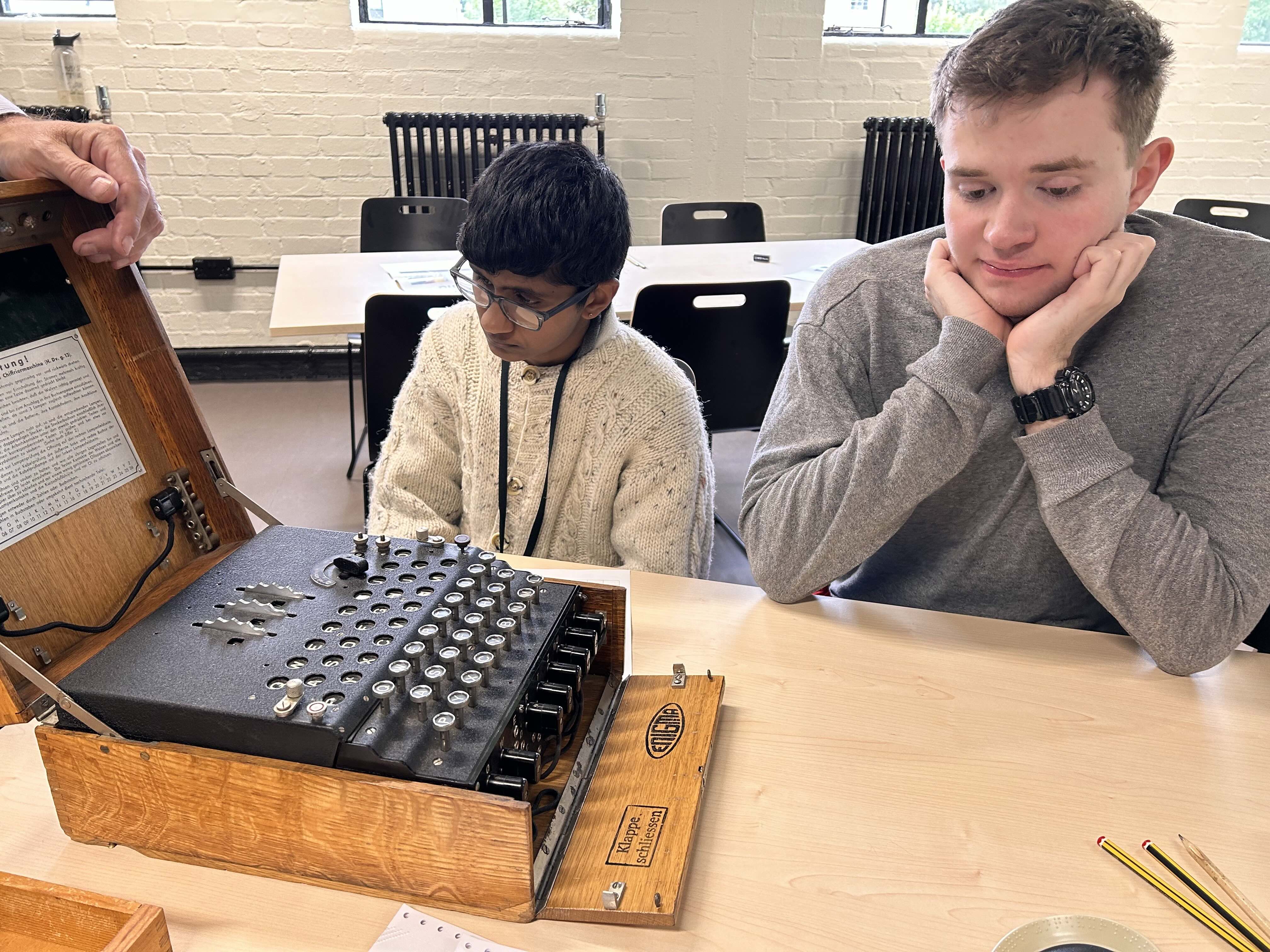 two students exploring the Enigma machine