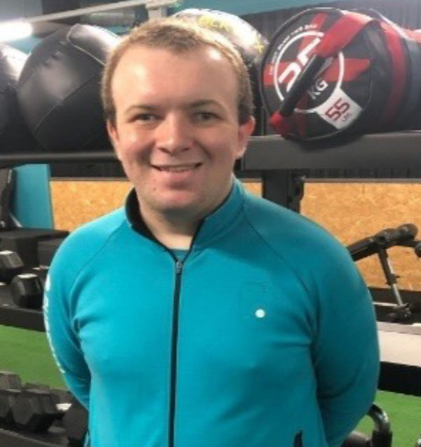 A head and shoulders portrait of Jack in a gym setting