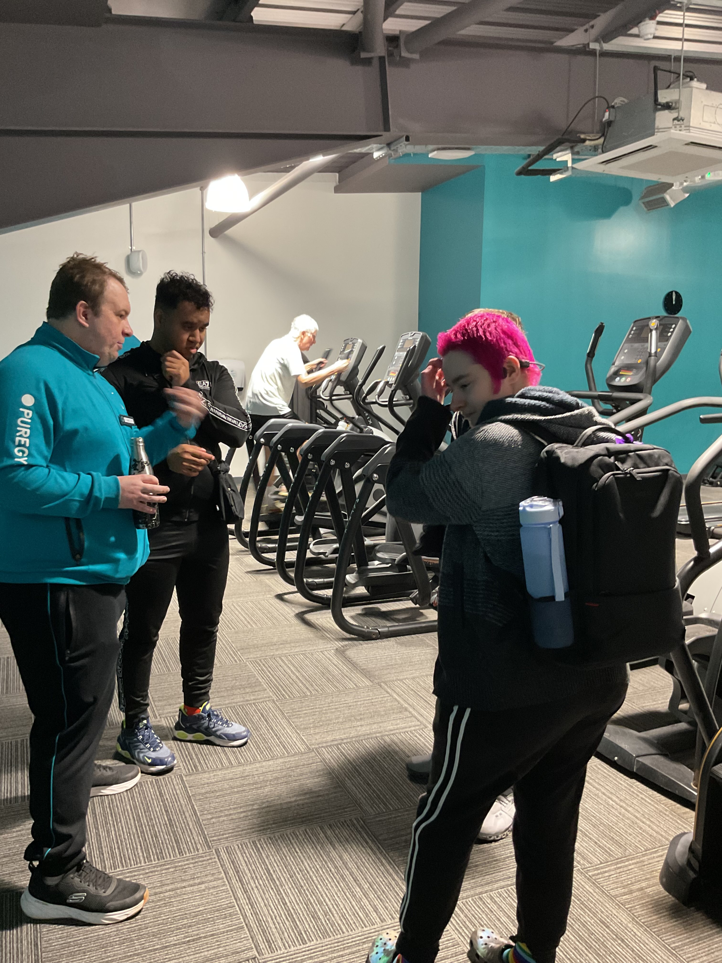 touring the facilities - in the gym area Jack talks two students through the equipment