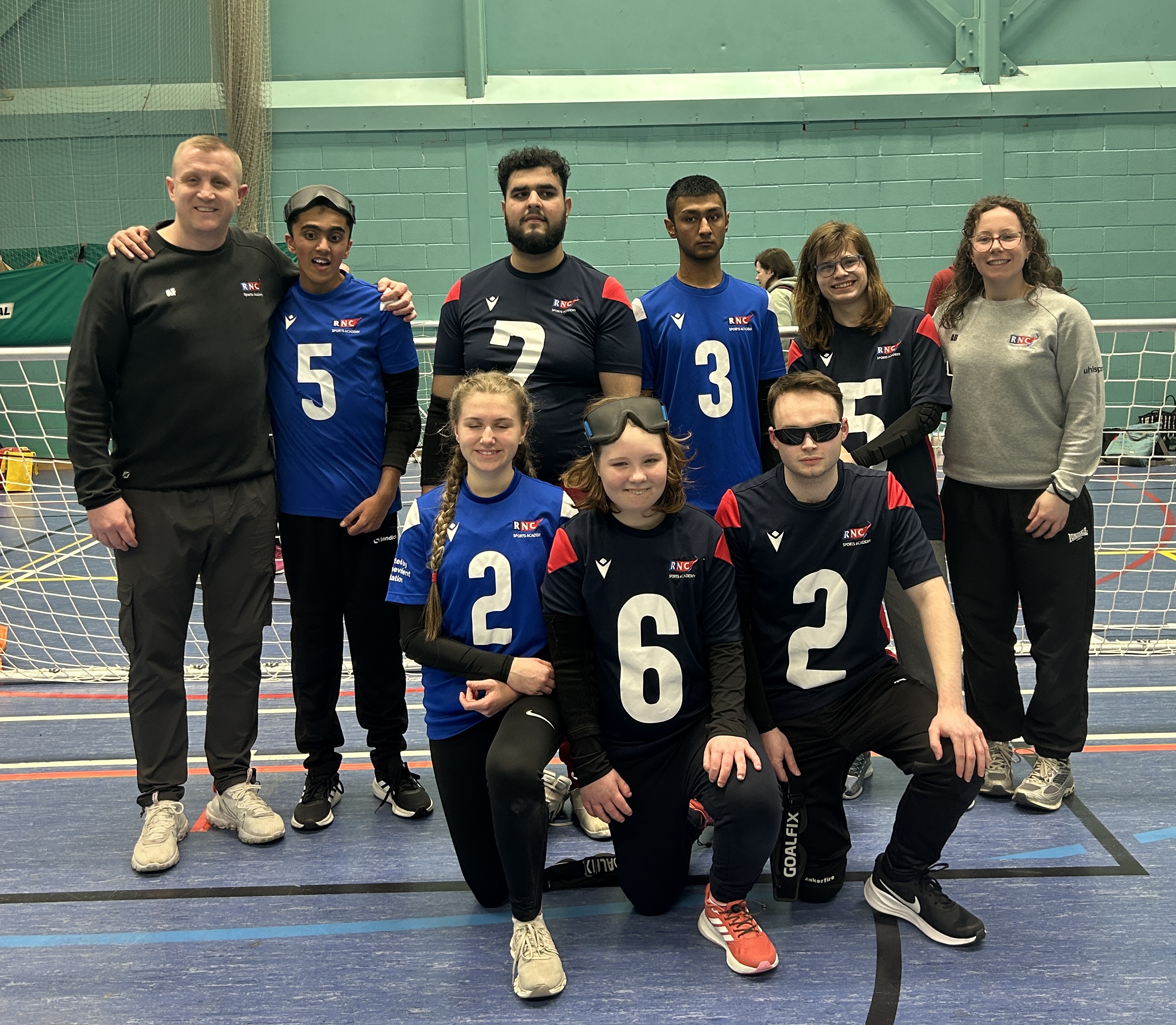 the full squad and coaches line up for a squad photo
