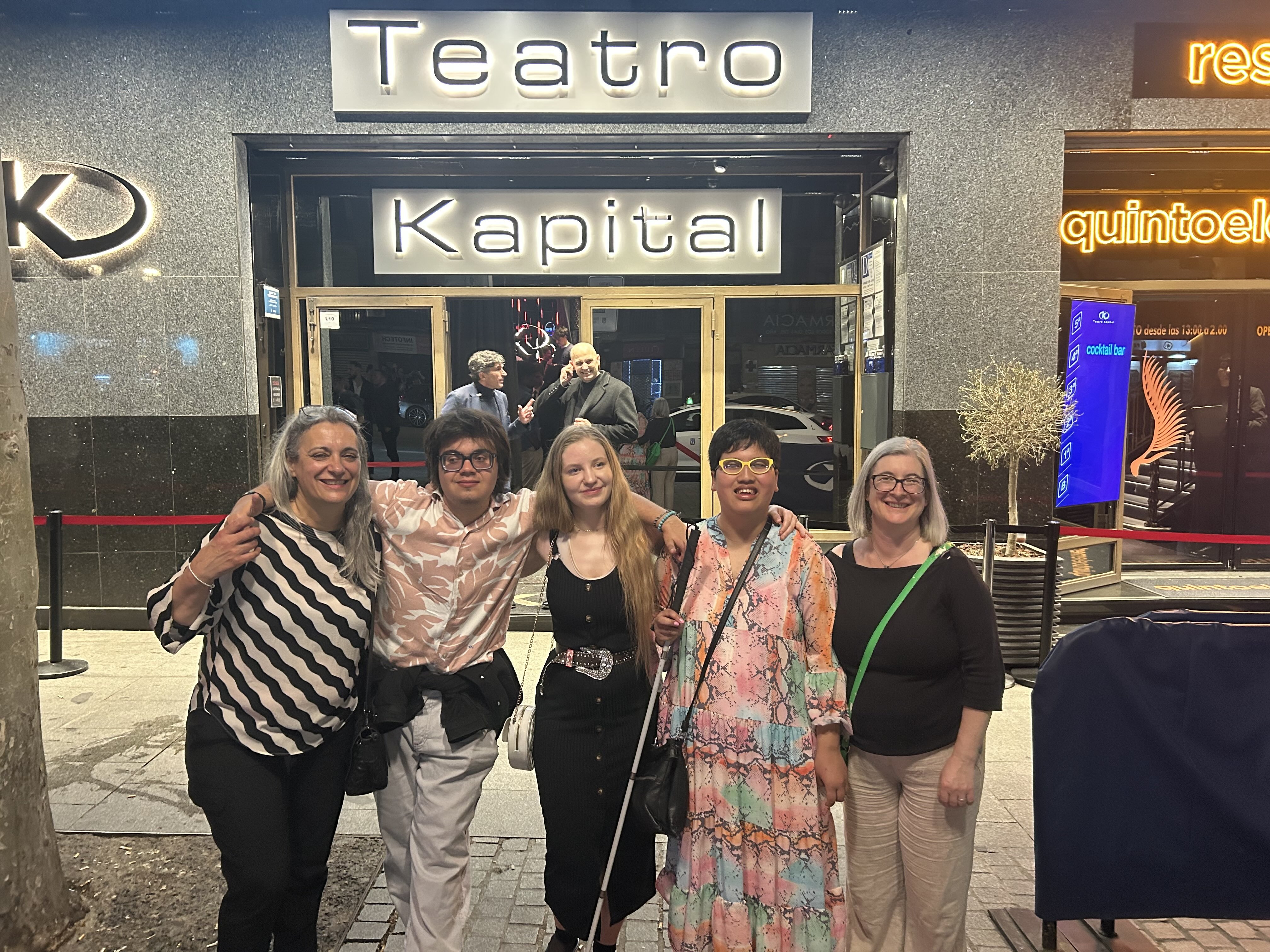 A group of 5 - 3 students and 2 staff - stand outside the nightclub